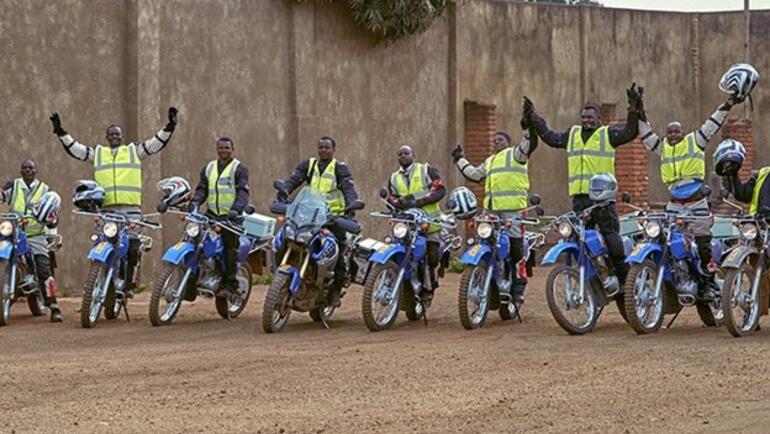 Nine Riders for Health cheering on their motorcycles in Malawi