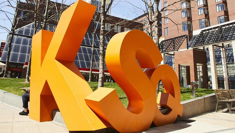 A sculpture of Kendall Square's initials in front of the Boston Marriott Cambridge.