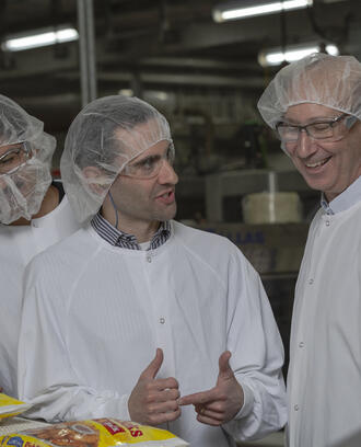 Two Ops-Lab students talking with host in Gorton's of Gloucester factory