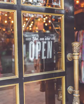 Open sign on clothing store.