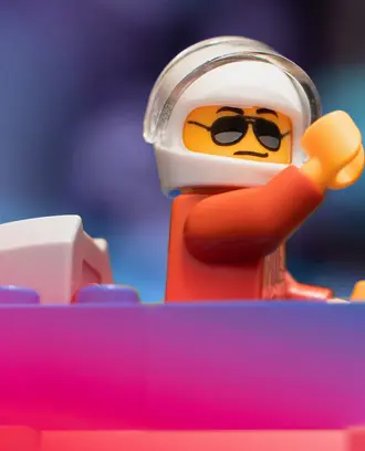 LEGO toy fighter pilot with his arm raised 