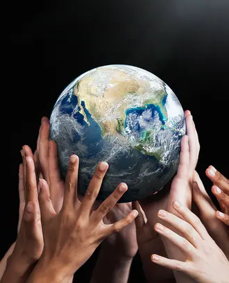 Hands holding up globe