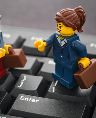 Lego business people on top of a keyboard