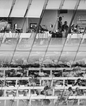 Sports media at a stadium in media area black and white