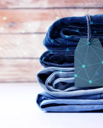 A stack of jeans with network/AI imagery overlayed on top