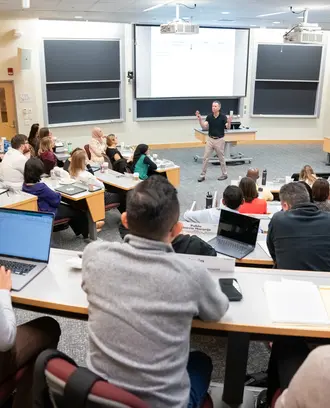 Professor Robert Gibbons teaching a full classroom