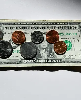 Coins on top of a dollar bill