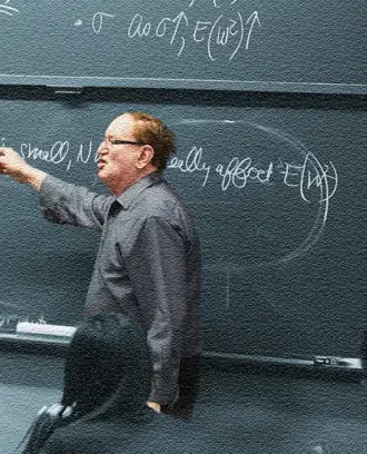Arnold Barnett teaching at a chalkboard.