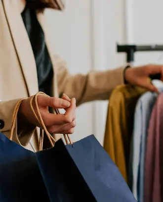 A customer peruses a rack of clothes