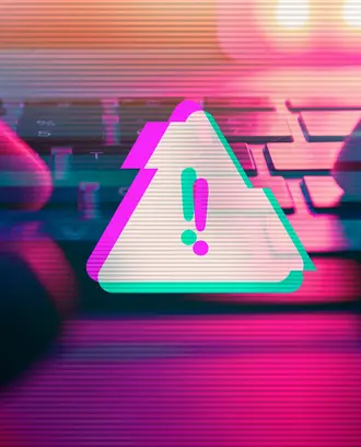 A person types on a keyboard with a malware virus alert