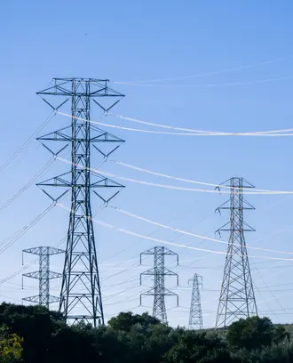 Electrical transmission towers and lines against a blue sky