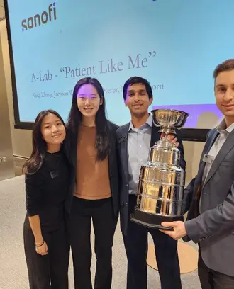 Winning A-Lab Vitalytics team holding large trophy. 