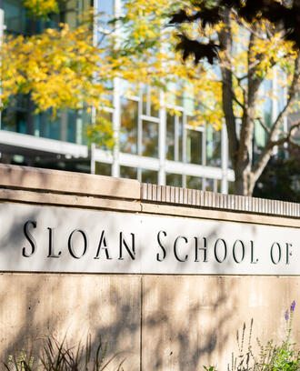 Inscription on wall outside of building E62 reading MIT Sloan School of Management