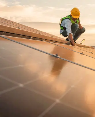 A person does work on a solar roof
