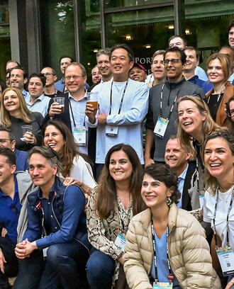 A large group of people poses for a photo off camera