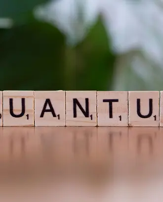 Scrabble pieces spell out the word "Quantum"