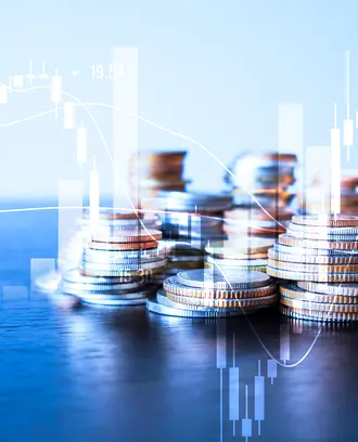 A stack of coins is overlayed with a stock ticker and bar charts