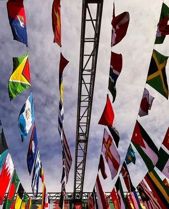 Many nations' flag fly in the sky.