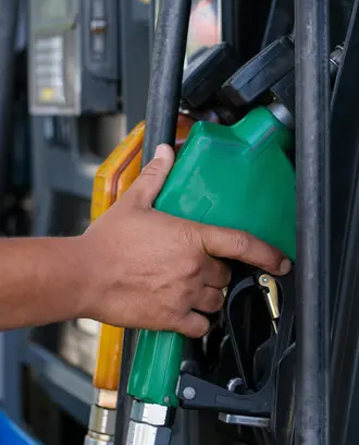 A Person's Hand Holding a Gas Pump