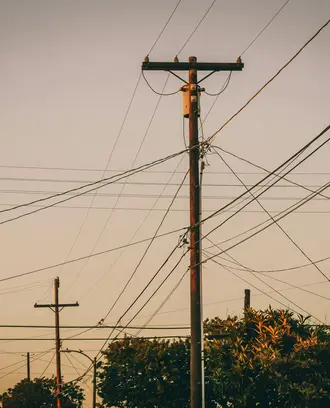 Brown Electric Post Under Gray Sky