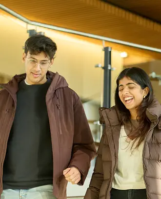 Two people talking while walking down stairs
