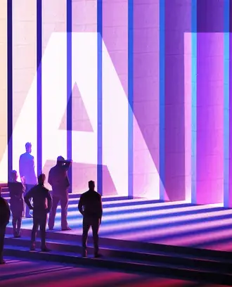 A group of business people look at a wall made up of panels with the letters "AI" on it