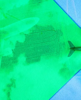 An airplane flies across the green sky, revealing the new green technology like solar and green aviation fuel