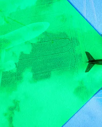 An airplane flies across the green sky, revealing the new green technology like solar and green aviation fuel