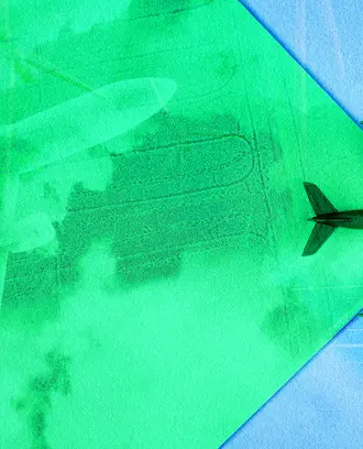 An airplane flies across the green sky, revealing the new green technology like solar and green aviation fuel
