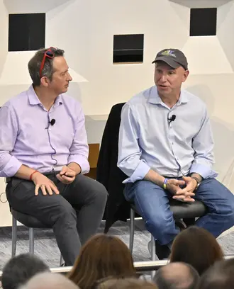 Panel of four people discuss topics onstage