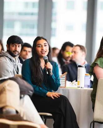 ClimateCAP attendee holding microphone in audience