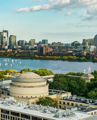 Aerial view of Boston across the Charles River with the MIT Great Dome in the foreground.