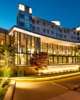 River side of MIT Sloan Building E62 at dusk