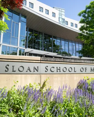 Exterior photo of MIT Sloan's main building E62 with plants