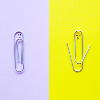 One paperclip is intact and another paperclip is open.