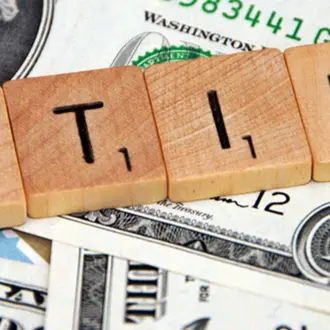 Scrabble letters spelling out "retire"