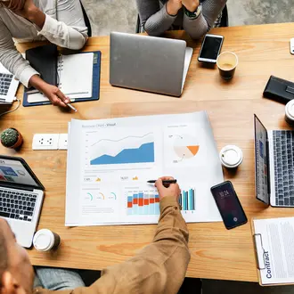 People discussing charts around table