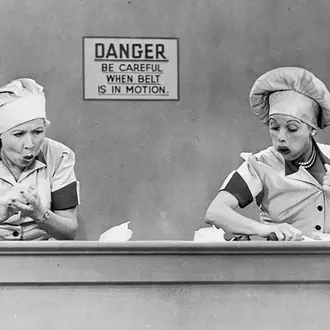Still of Lucy and Ethel working at the candy factory from I Love Lucy 