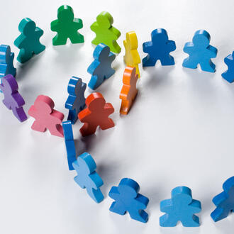 Multicolored wooden people illustrating a business concept - networking or teamwork.