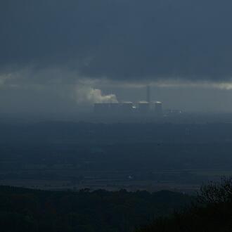 Coal pollution from a power plant shown in distance.