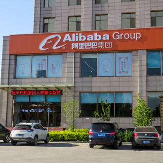 A photo outside of an Alibaba office building with Alibaba orange signage.