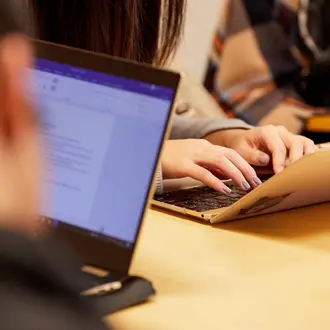 A photo of students working on a computer