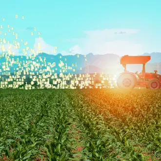 A photo illustration of a smart tractor with binary code coming out of it