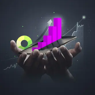 A hand holding a tablet with various data graphs