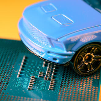 A toy car sits on top of a microchip