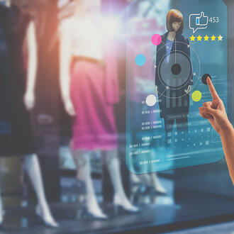 A shopper uses a smart technology screen in a retail store to choose, buy clothes, and give product rating