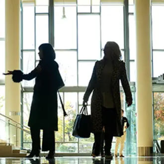 People walk the halls of E62.