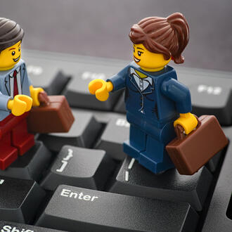 Lego business people on top of a keyboard