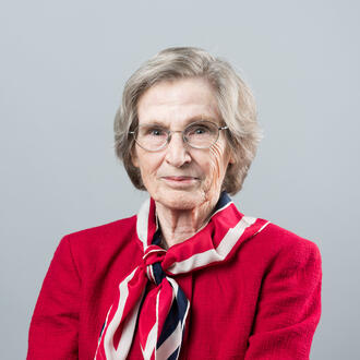 Image of MIT Sloan Professor Emerita Lotte Bailyn in a red jacket