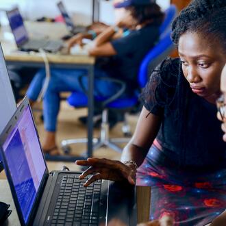Two people looking at computer screens